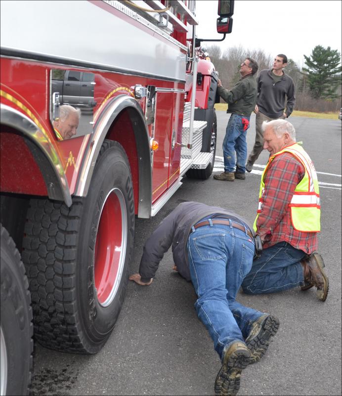 Several firefighters assessed the clearance of the truck and were pleased that it has more than the old tanker. (Photo by Lynda Clancy)