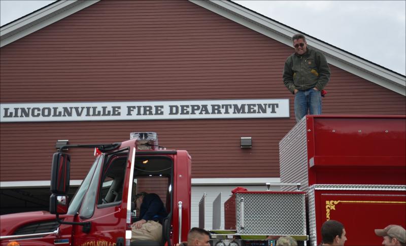 Mike Eugley gets perspective from the roof. (Photo by Lynda Clancy)