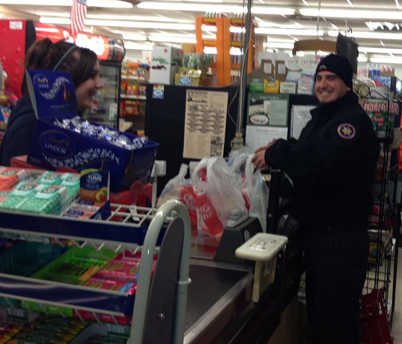 After rushing outside to aid a motorist who went off the road on Route 90 in Warren, paramedic Kevin Montoya returns to Lincoln's Country Store and finishes his grocery shopping. (Photo by Lynda Clancy)