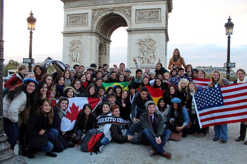 The author (just above the stars on the furthest of two American flag) poses in front of the Arc de Triomphe with fellow travelers on a Rotary-organized trip from Belgium to Paris.