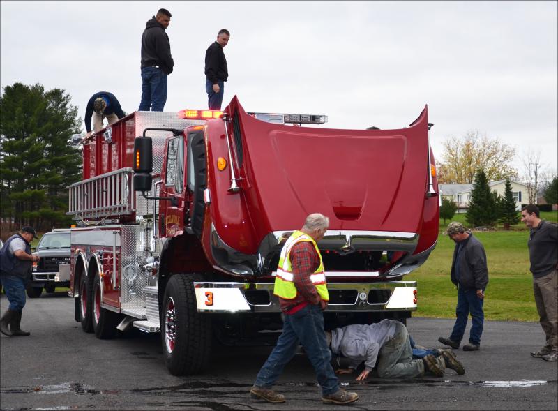 Lincolnville's Fire Department welcomed its brand new tanker on Saturday, Nov. 3, and immediately, firefighters were inspecting every aspect of it. (Photo by Lynda Clancy)