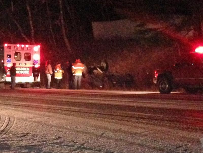 An unidentified man was trapped upside down by his seat belt after his truck overturned on slippery Route 90 in Warren Wednesday evening. (Photo by Lynda Clancy)