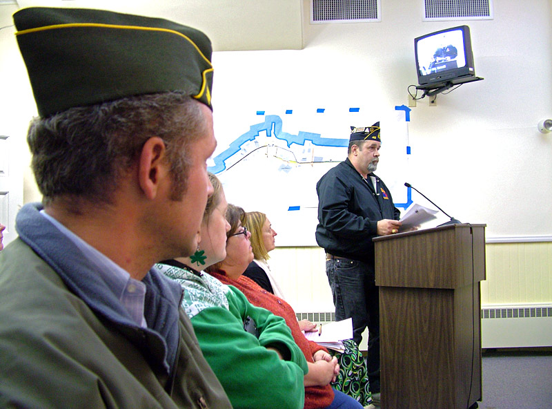 Veteran Timothy Parker, at the podium, was one of a number of residents who came to City Hall on Tuesday night to speak out against the idea of putting creative lighting and seating on the footbridge, officially known as the Armistice Bridge. (Photo by Ethan Andrews)