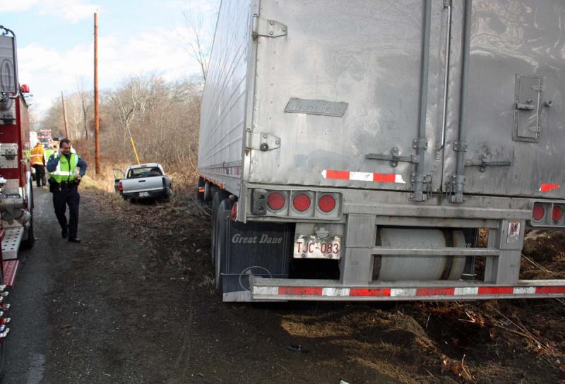 According to officials, had the big rig been a few seconds closer to the intersection, Floyd Hews and his pickup truck would have ended up under the trailer. (Photo by Holly S. Edwards)
