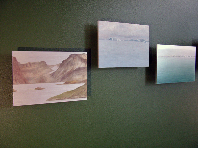 Small paintings by Lisa Lebofsky. At far left, a retreating glacier peeks between two mountains but no longer reaches the sea (Photo by Ethan Andrews)