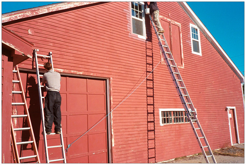 SEARSPORT - Peter Taliaferro, left, and Brad Buttrick of the two-man painting company The Classic Brush, spruce up the facade of the new Sundog Solar Store a week before the company moved to the new building, a mile-and-a-half up Route 1 from its original downtown location.