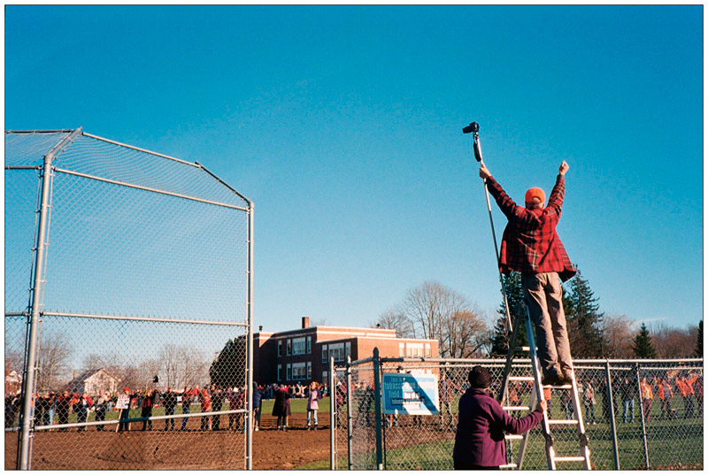 BELFAST - Peter Wilkenson directs opponents of a planned propane terminal in Searsport. Using a camera mounted on a pole, he photographed the protesters joining hands in a circle the diameter of the 22.7 million gallon storage tank that would be part of the development.