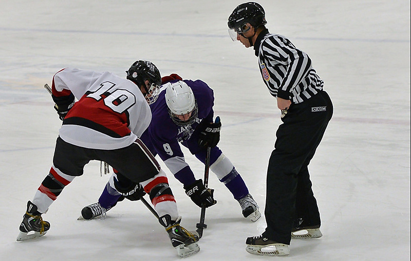 Camden Hills Stephen Hand wins a face off. (Photo by Ron Hawkes)