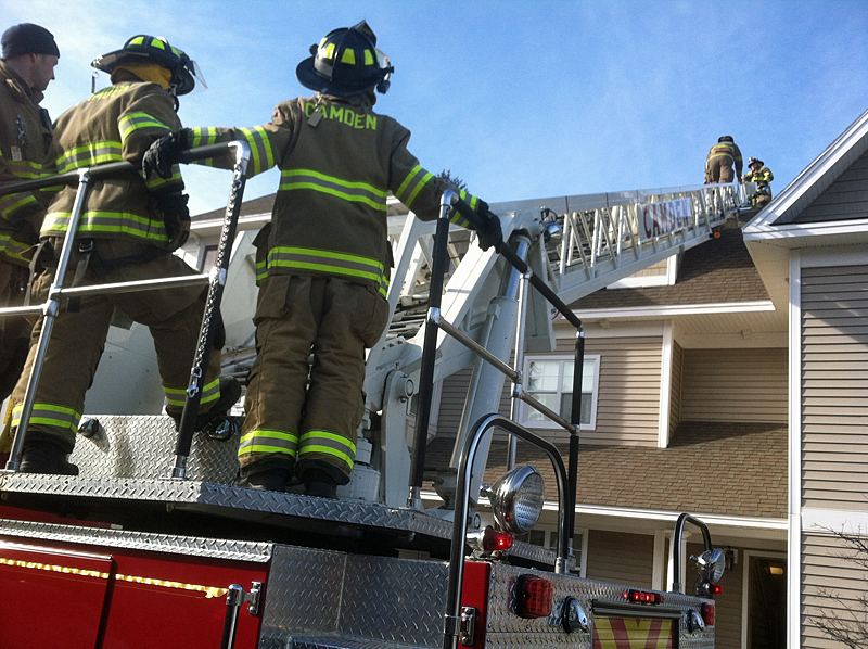 Firefighters Cheyne Hansen, Scott Entwistle and Mary Stiehler assisted with equipment and moving the patient at the bottom of the ladder. (Photo courtesy Justin Hills)