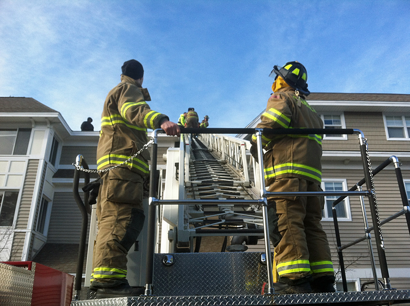 Firefighters Todd Anderson and John Wickenden brought the patient down the ladder from the fourth-floor roof. (Photo courtesy Justin Hills)