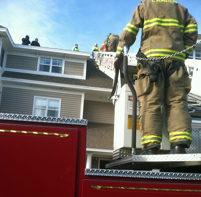 Paramedic Bill Bentley ran belay from the top of the roof, with EMT Brian Adams helping assess and package the patient. (Photo courtesy Justin Hills)