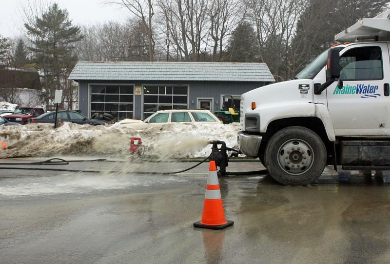 Water leaking from a broken pipe in Camden, flowing at 3,500 to 4,000 gallons per minute, is pumped out of a hole dug on Union Street by Maine Water crews Sunday. (Photo by Holly S. Edwards)