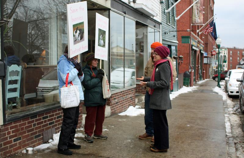 Rabbit sympathizers Wendy Andresen and Merrill Tucker outside Long Grain restaurant in Camden Saturday debating with a couple from Lincolnville. (Photo by Holly S. Edwards)