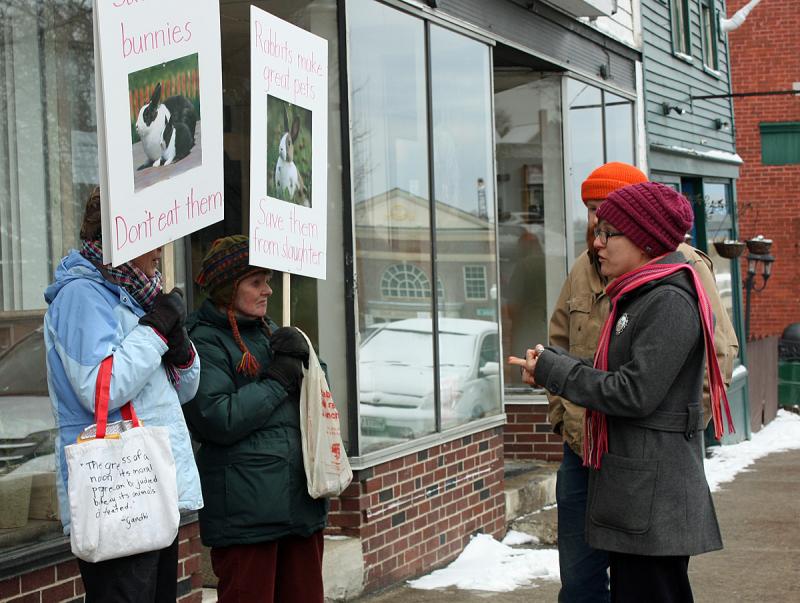 Joey and Tim, right, debate with protesters Wendy Andresen and Merrill Tucker in downtown Camden Saturday. (Photo by Holly S. Edwards)