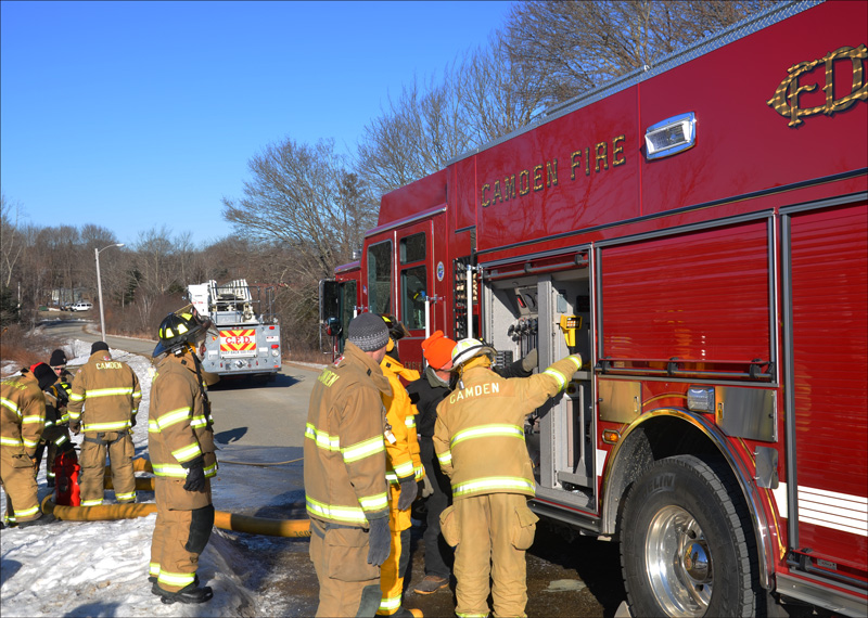 Camden firefighters Mary Stiehler, Cheyne Hansen, Tom Bland and Robert Stiehler. John Foxx, in the orange hat, is from Minute Fire and Rescue Apparatus, Inc., in Walpole, Mass., and is training Camden firefighters on Engine 4 features. (Photos by Lynda Clancy)