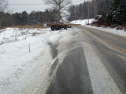 Tracks in the road show the pickup truck's path off the road. (Photo by David Edwards)