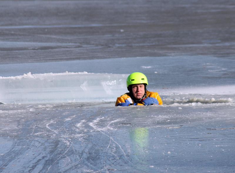 Rockland firefighter Mike Cole waits to be rescued during training on Chickawaukie Pond Saturday. (Photo by Holly S. Edwards)
