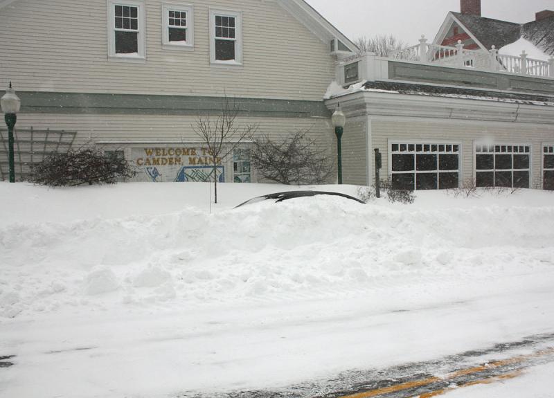 A car left parked on Elm Street in front of RiteAid is buried in snow. (Photo by Holly S. Edwards)