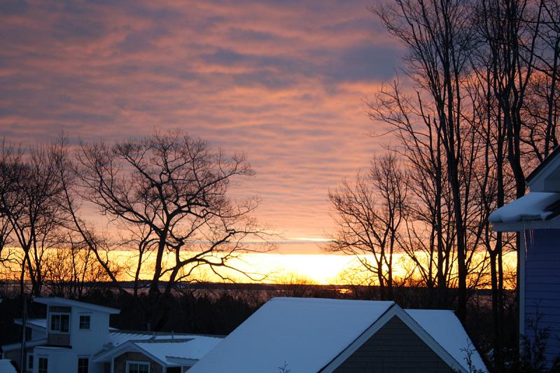 Deep, thick clouds hover over the coast, broken only at the horizon where the sun moves upward. (Photo by Holly S. Edwards)