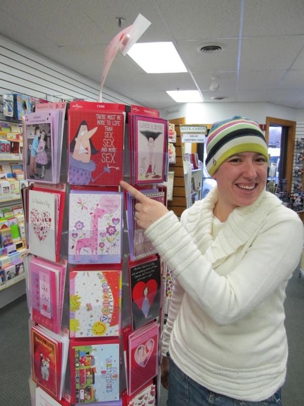 Danica Fullington poses with the sexy cards on the top rack at Sherman's (photo: Kay Stephens)
