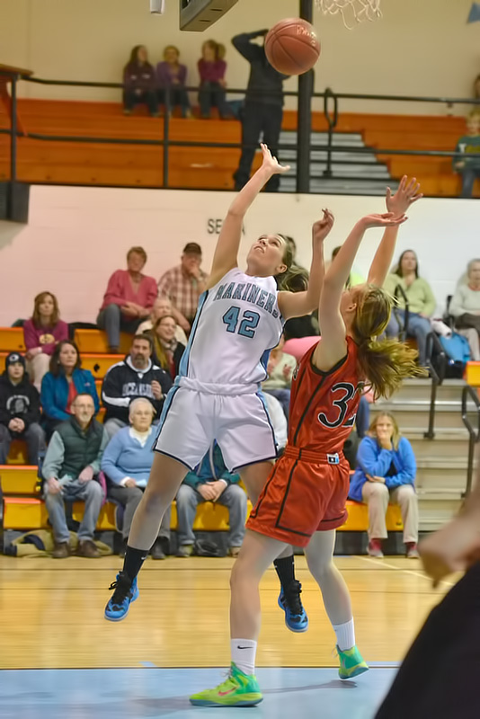 Oceanside's Brooke Dugan flys past Camden Hills Jordan Knowlton with a lay up early in the game. (Photo by Ron Hawkes)