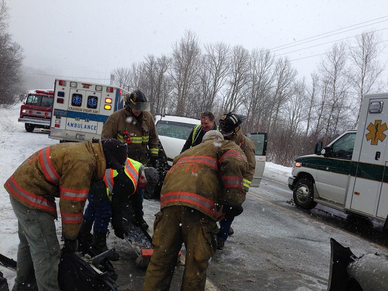 Firefighters pick up car parts off Route 17. (Photo by Lynda Clancy)