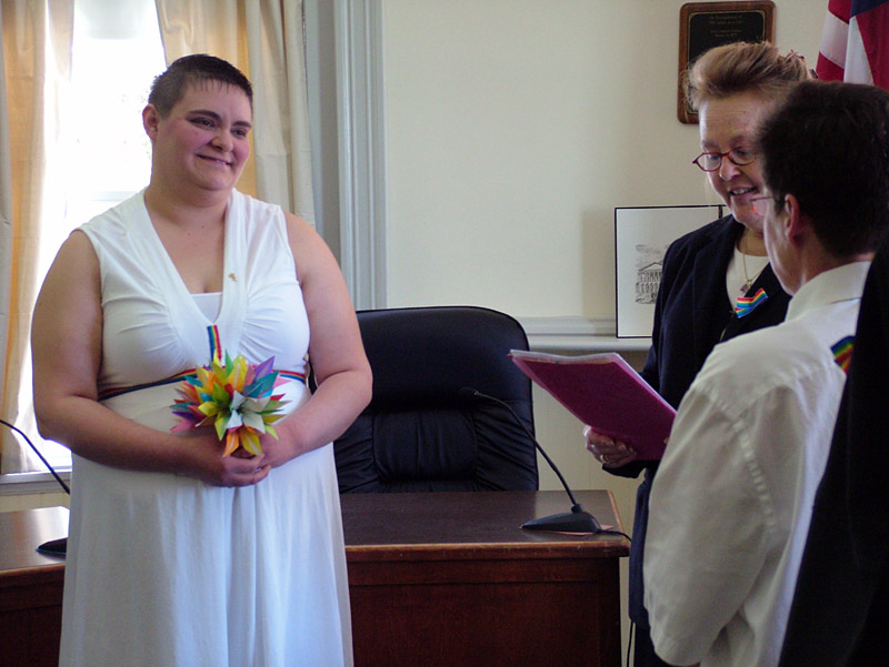 Opal Ash, left, holds a bouquet of origami flowers during wedding ceremony. (Photo by Ethan Andrews)