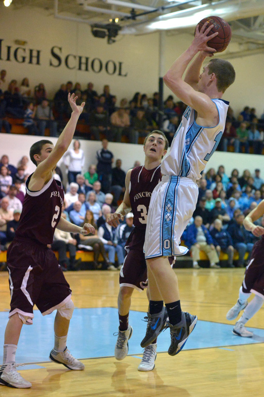 Oceanside's Hunter Grindle goes up high over the Foxcroft Academy defenders with a shot for two of his 10 points. (Photo by Ron Hawkes)