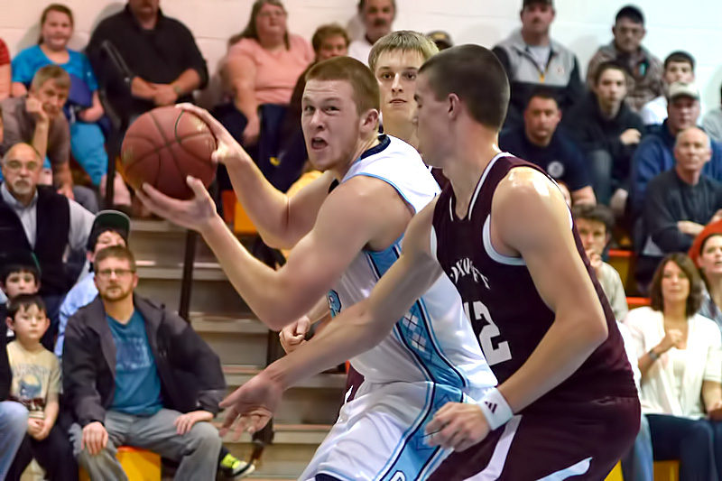 Oceanside's Sam Meklin, left, looks to put the ball up as Foxcroft Academy's Kolby Kendall defends. The Ponies won 55-45. (Photo by Ron Hawkes)