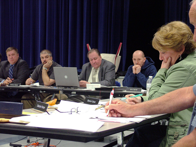 RSU 20 board member Sharon Catus, far right, pauses during emotion-filled comments to the board about the proposed reorganization of her town's elementary school. (Photo by Ethan Andrews)