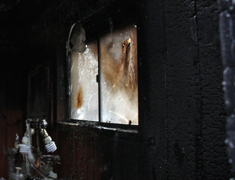 Charred walls and smoke-smudged windows inside the burned home on Marrs Hill Road. (Photo by Holly S. Edwards)