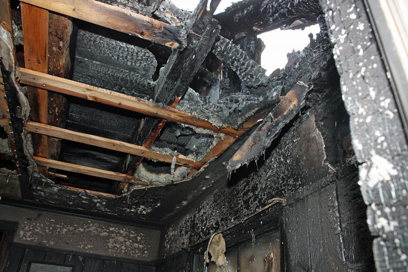 A wider view of the back of the home where fire burned through the roof. (Photo by Holly S. Edwards)