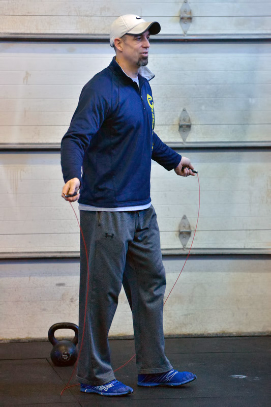 Coach Jason Foster discusses the WOD for the Throwdown with a member that is waiting to compete. (Photo by Ron Hawkes)