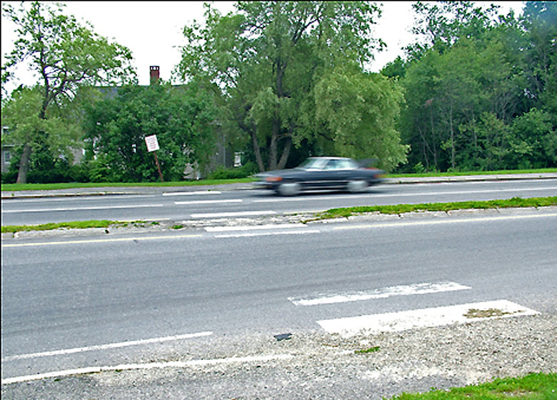 Crossing Route 1 at Route 141 in Belfast was famously risky undertaking before 2009 when the city began a series of improvements aimed at slowing traffic and making safer crossings. The original crosswalk, since relocated, is pictured here. A second round of improvements is in the works. (Photo by Ethan Andrews) Crossing Route 1 at Route 141