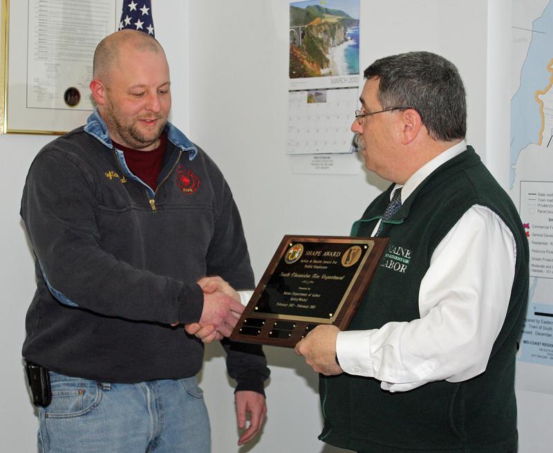 South Thomaston Fire Chief Bryan Calderwood accepts the SHAPE Award from Occupational Safety and Hazard Program Supervisor Mike LaPlante of the Maine Department of Labor. (Photo by Holly S. Edwards)