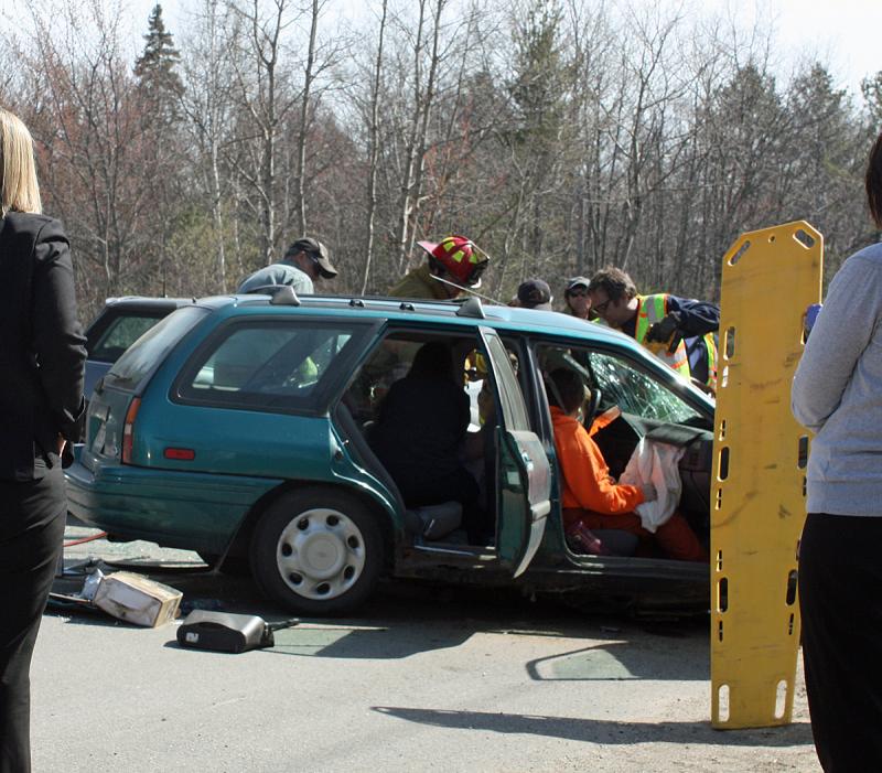 Melissa Parker of Lincolnville waits to be removed from the Ford Escort Monday afternoon. (Photo by Holly S. Edwards)