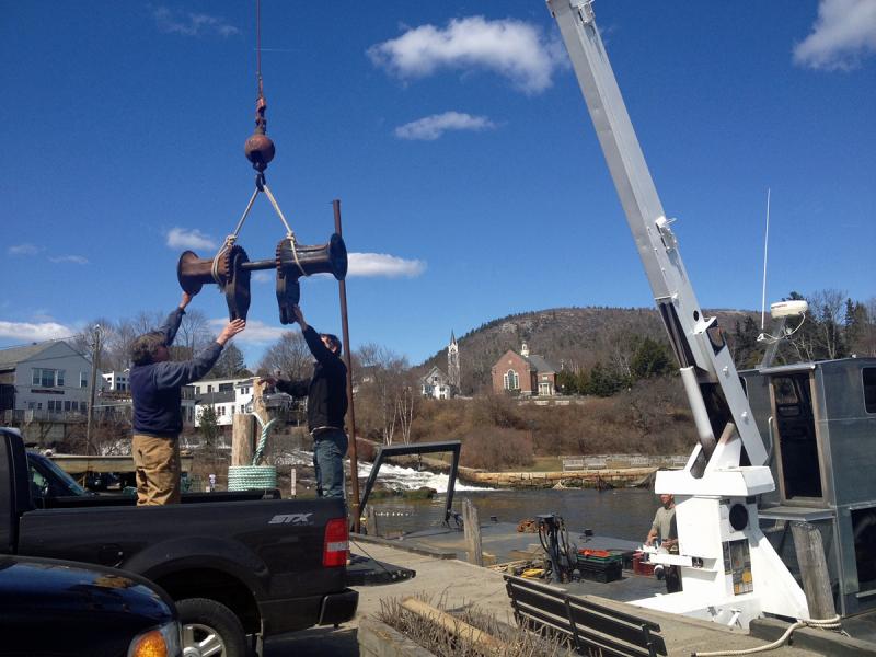 Capt. Mike McHenry gets help from Two Harbor Marines' new mobile marine crane to swap out an old anchor windless from the windjammer Angelique. (Courtesy Steve Pixley)