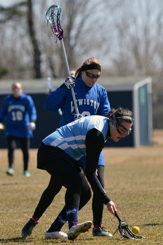 Oceanside's Karly Robinson scoops up a ground ball during Saturday's game against Lewiston Varsity. (Photo by Ron Hawkes)