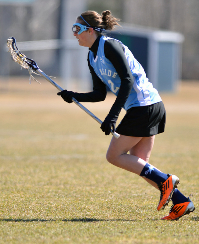 Oceanside's Lily Vachon takes off after picking up a ground ball. (Photo by Ron Hawkes)
