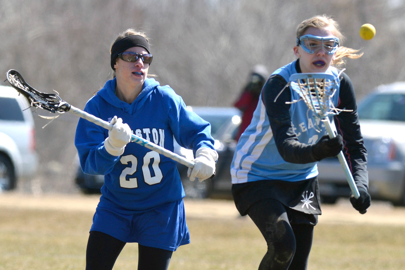 Oceanside's Riley Pillsbury, right, tries to gain control of a loose ball during play Saturday. (Photo by Ron Hawkes)