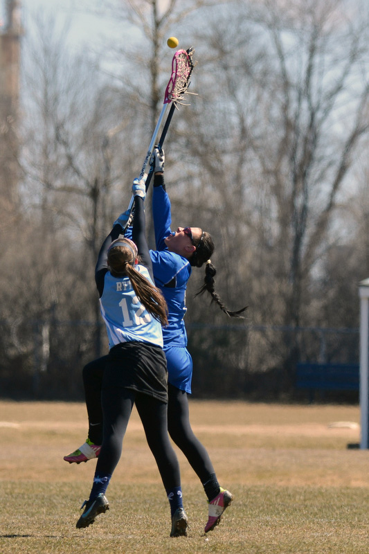 Oceanside's Brittany Rytky battles with a Lewiston player for control of this ball. (Photo by Ron Hawkes)