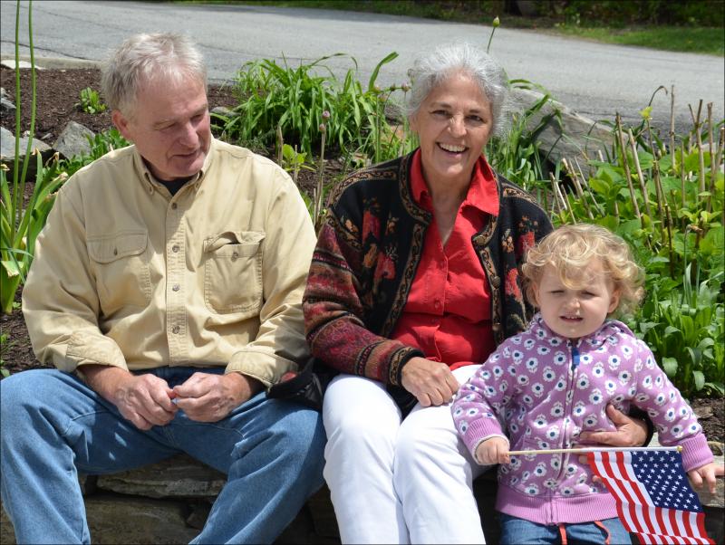 Taylor Allen and Martha White, and their granddaughter, wait at the Rockport Corner Shop for a parade. (Photo by Lynda Clancy)