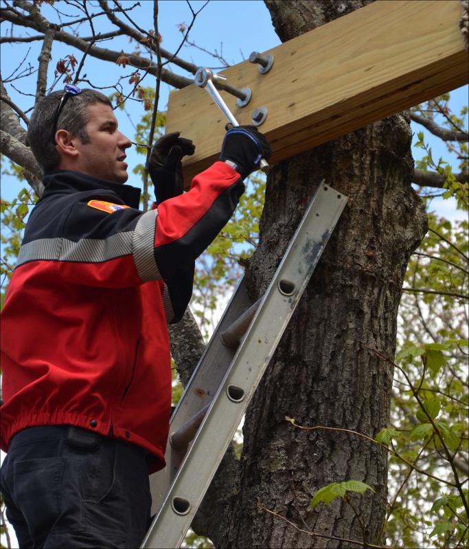 Camden's Assistant Fire Chief Andrew Lowe ratchets a bolt into place.