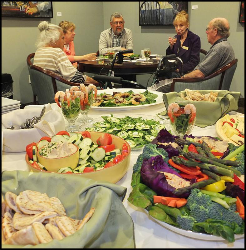 Residents and guests enjoy one of the many tables of food Saturday.