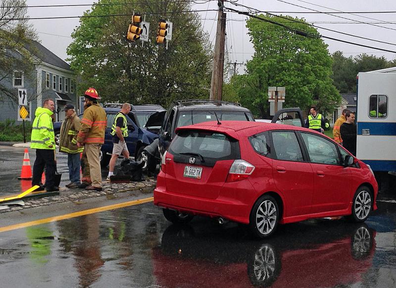 Rockport's new fire chief, Jason Peasley, far left in yellow, spends day two helping tend to Tuesday's accident at routes 17 and 90. (Photo by Lynda Clancy)