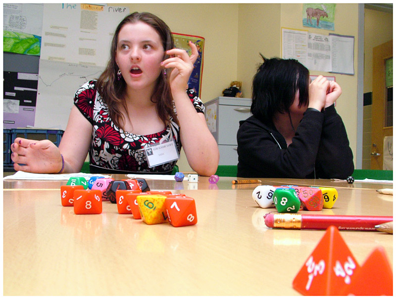 Samantha Sullivan, left, reacts during a session of the role-playing game Pathfinder. Sullivan and fellow middle schooler Lille Gates, right, are part of a new group of students from Western Waldo County that has been able to tap into the Game Loft since the Belfast-based after school program launched its satellite program at Mount View School last fall. (Photo by Ethan Andrews)