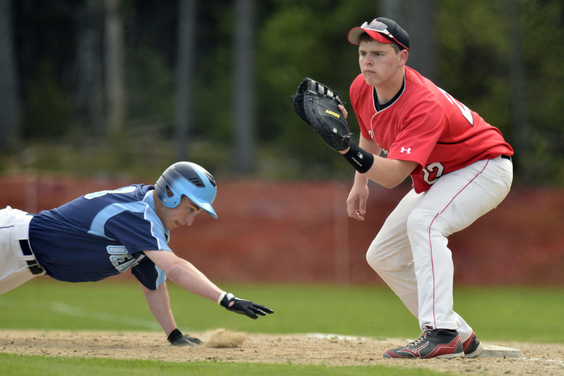 Oceanside's Zac Roman, left, dives back to first as Camden Hills Connor Graffam waits on the ball. (Photo by Ron Hawkes)