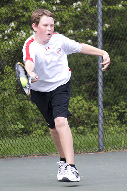 Camden Hills Drew Holt reaches for a return on a serve. (Photo Courtesy of Dwight Pitcairn)