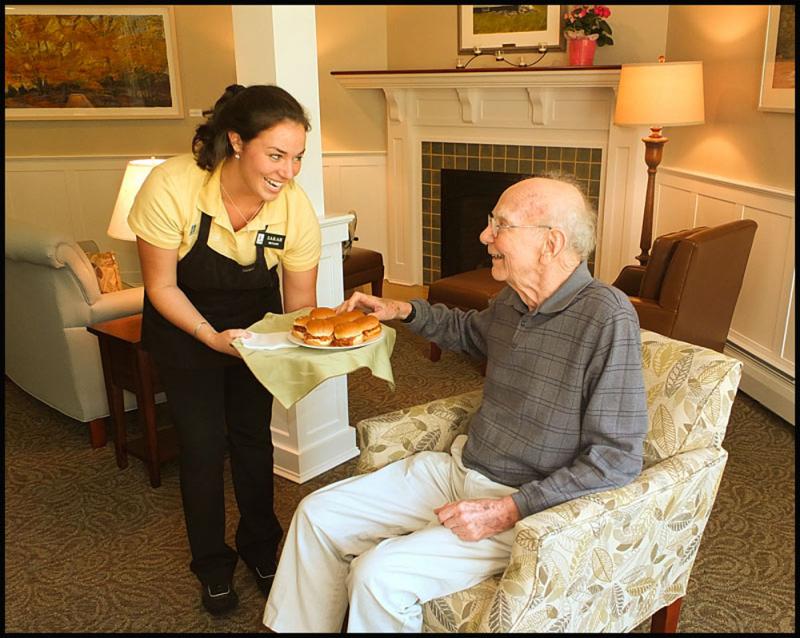 Sarah Bryant (housekeeping and dietary) serves Bartlett Woods resident Richard Neville during the open house on Saturday. "I've been here two weeks," he said. "So far it's been wonderful." (Photos by Chris Wolf)