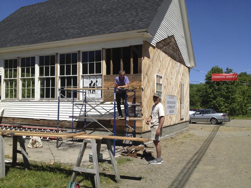 Paul Cartwright, left, and Andy Oliver describe the progress they’re making on renovating the former schoolhouse and turning it into the new Lincolnville Community Library. (Photo by Sheila Polson)